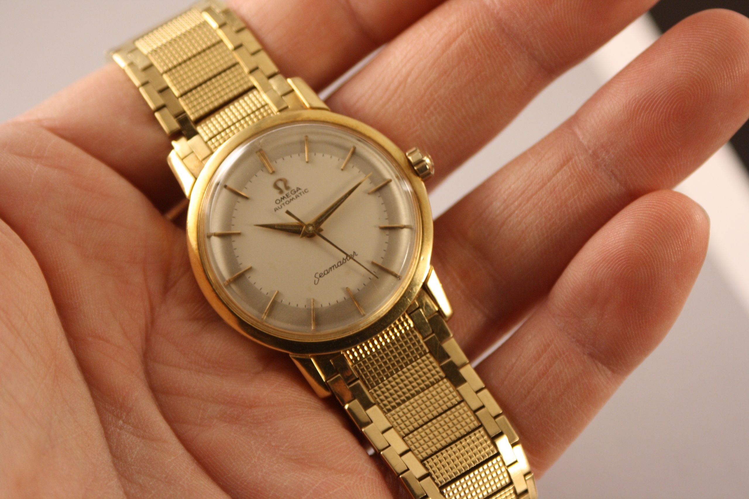 Rare Omega in yellow gold with integrated bracelet from the 1950s   VINTAGE TIMES AMSTERDAM