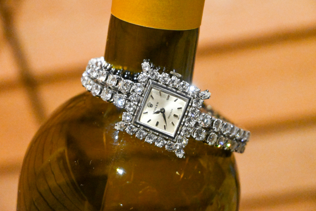 diamond rolex on wine bottle