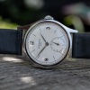 1946 Patek Philippe 565 in stainless steel resting on Extract from the Archives document