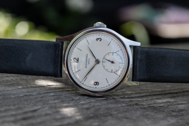 1946 Patek Philippe 565 in stainless steel resting on Extract from the Archives document